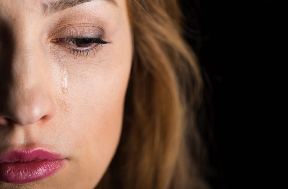 Close-up view of young crying woman's face